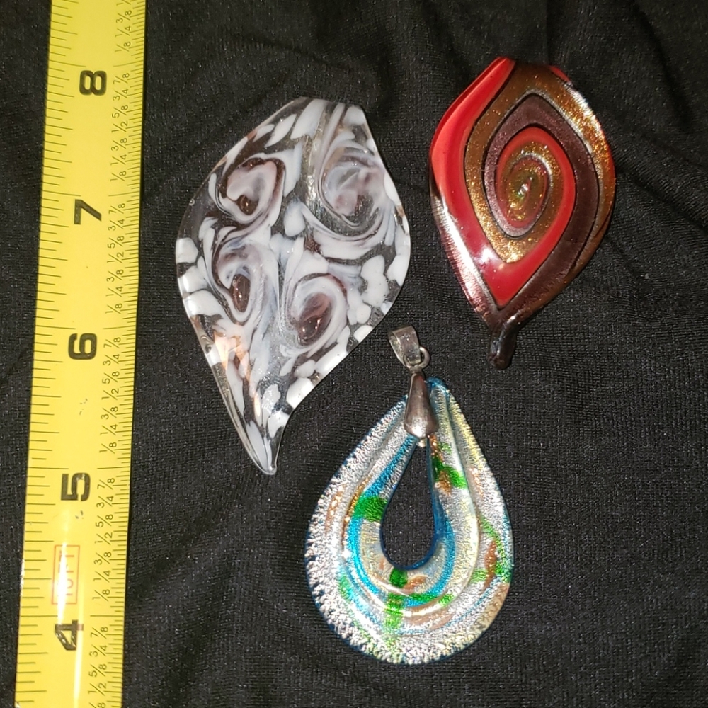Three hand crafted glass pendants